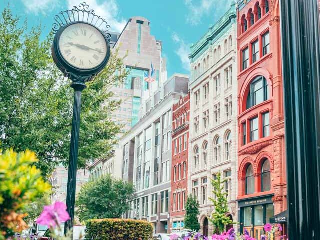 Downtown Louisville on a sunny spring day with historic clock and flowers