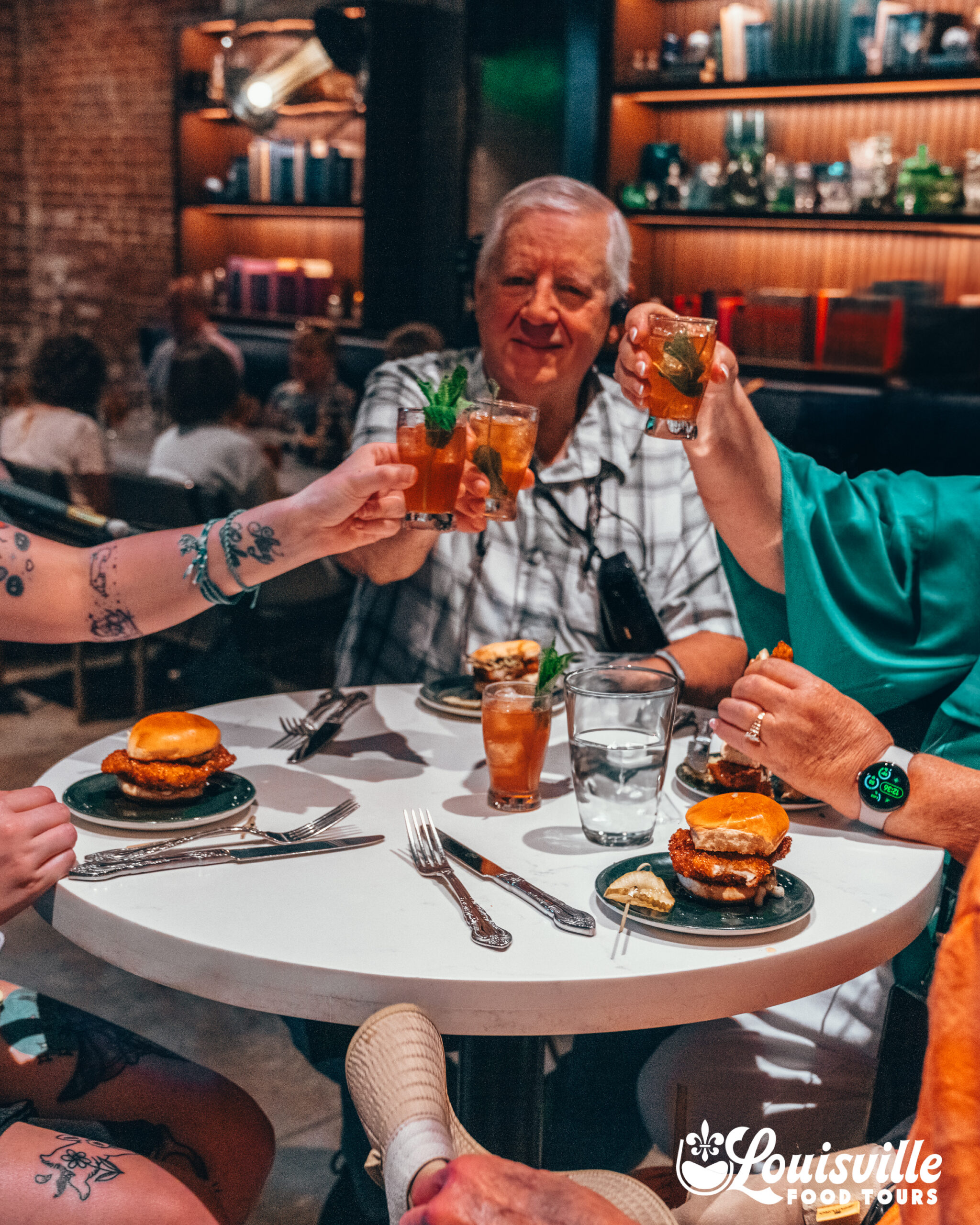 Group with Mint Juleps cheers on a food tour in Louisville Kentucky