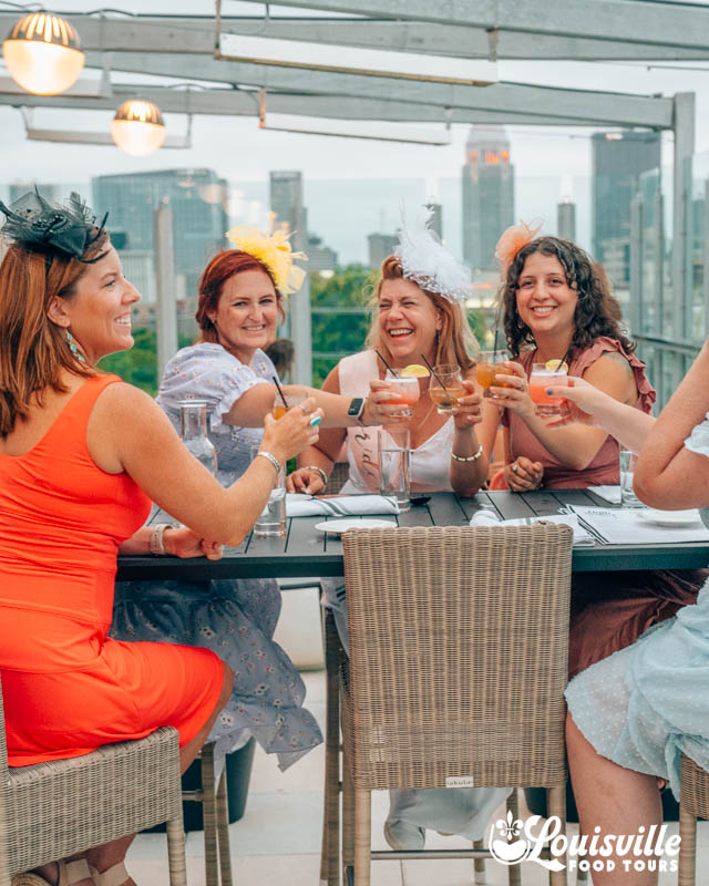 Bachelorette Party cheers at a rooftop bar at sunset in Louisville Kentucky