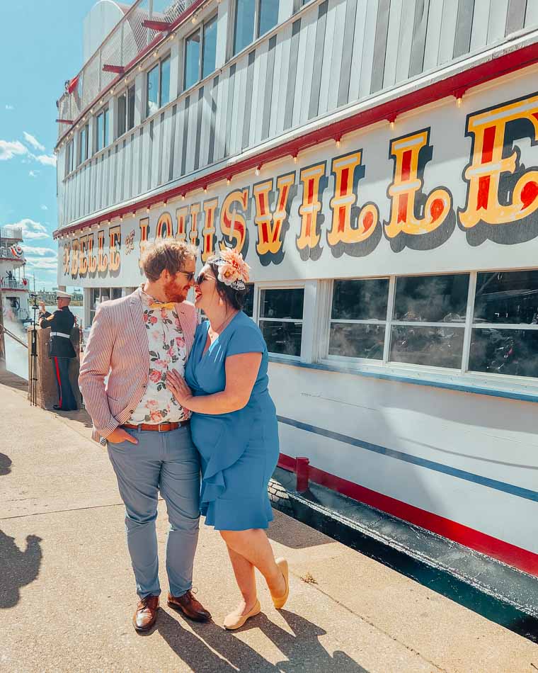 Lia and Jeremy Garcia founders of Louisville Food Tours, in Derby attire at Belle of Louisville