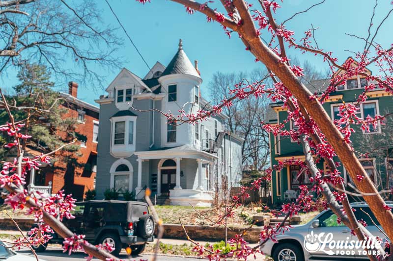 Historic Victorian homes in the Original Highlands in the spring with blooming flowers in Louisville, Kentucky